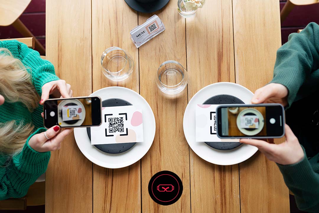 Image of two people scanning a QRcode on their plate